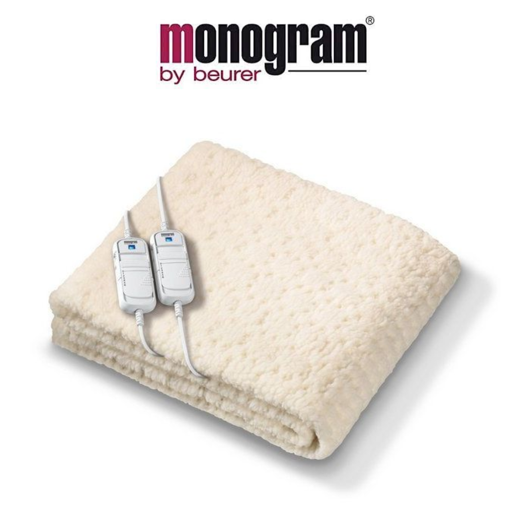 Monogram by Beurer Heated Blanket with Dual Controls Monogram by Beurer cream-coloured heated blanket with a textured surface and two attached controllers for personalised heat settings.